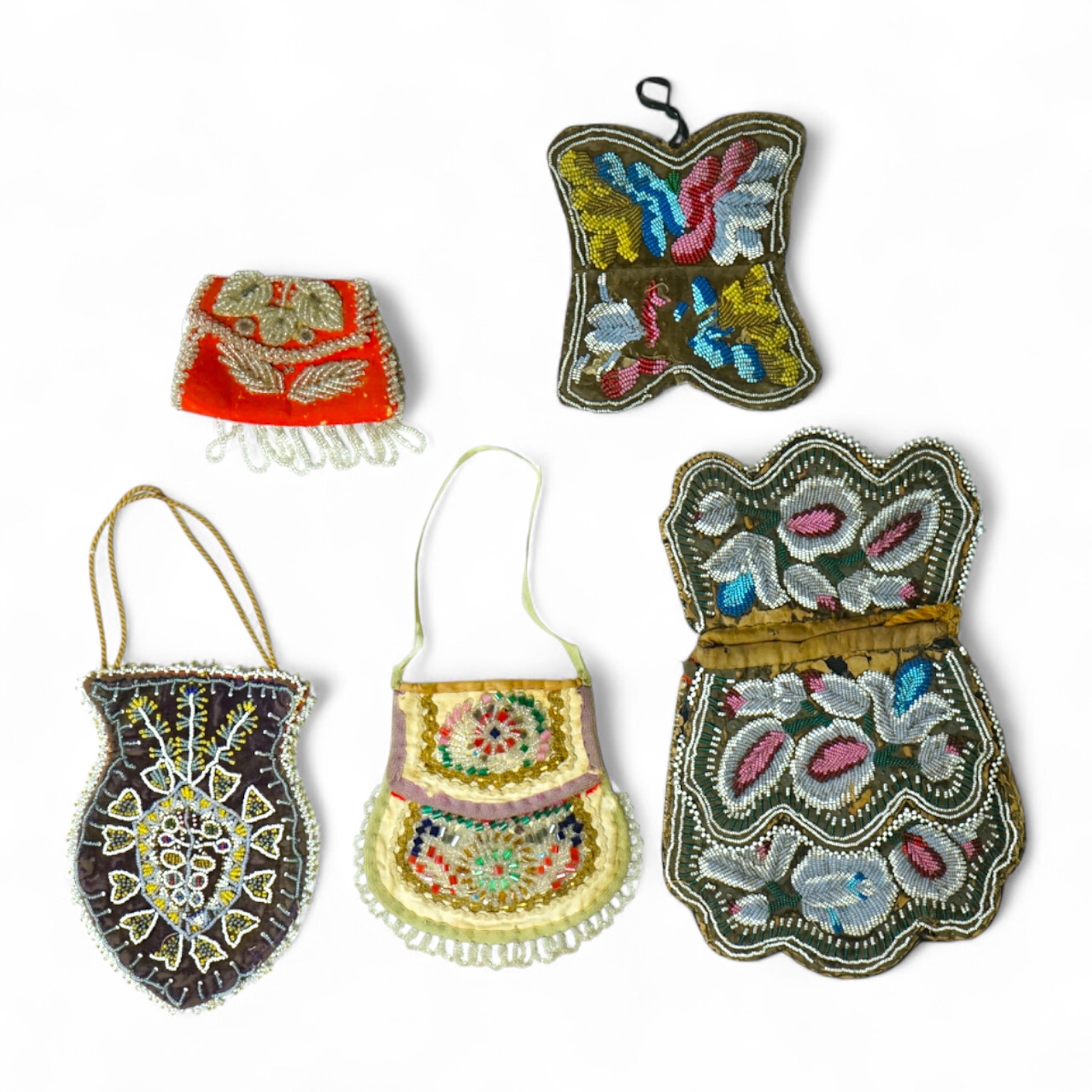 Five 19th century Native American beaded bags. Including a red felt coin pouch, three varying sized bags and a beaded panel.(5) Condition - four have damage to the fringing and beading and backing cloth. The light bag th